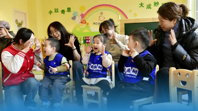 Children playing with teachers at Chinese school